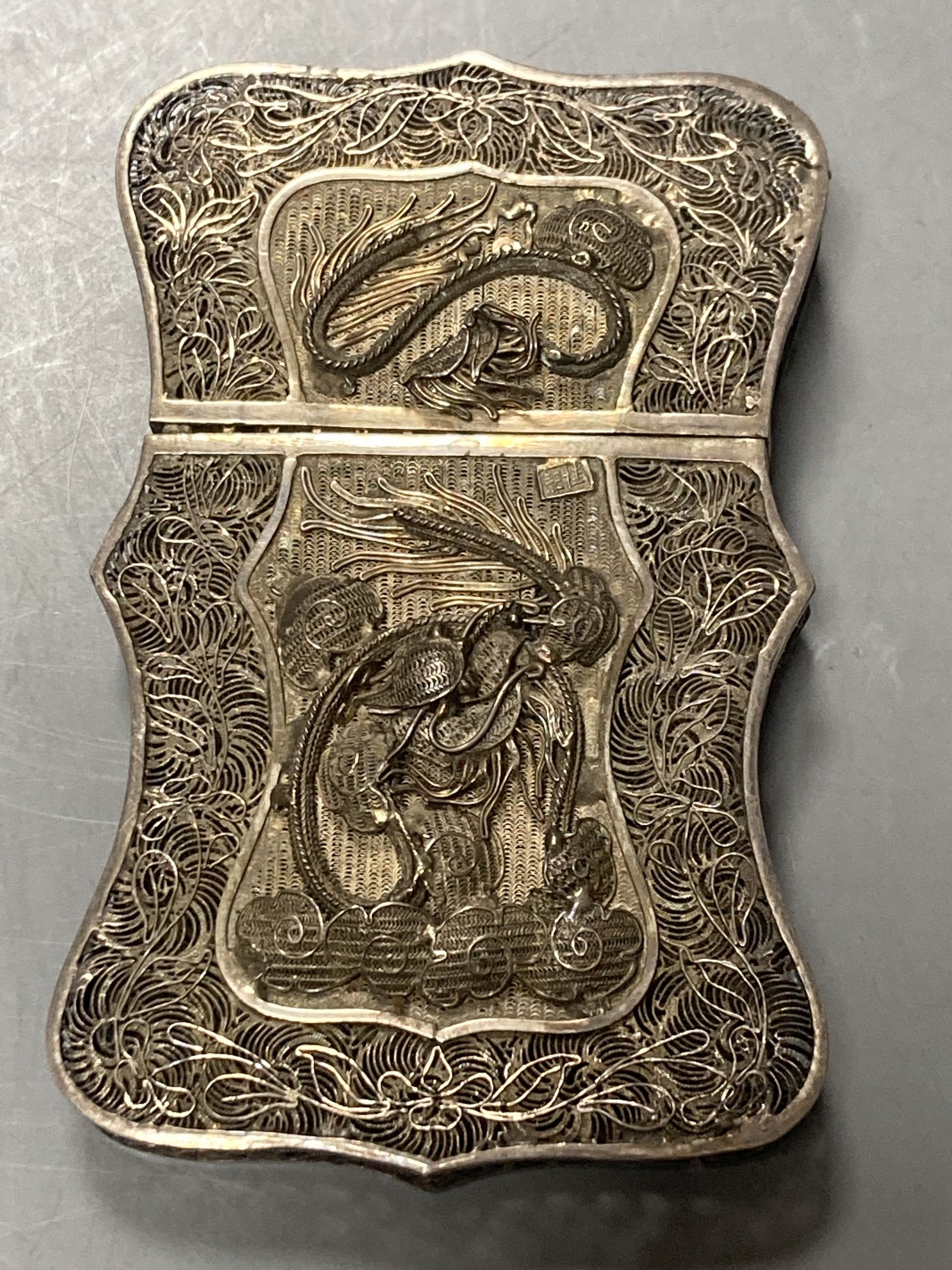 Two Chinese white metal filigree card cases, one with enamel(a.f.) & an Indian white metal snuff box, largest 91mm.